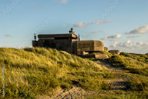 Fotografie, Obraz Six teenagers on a german bunker, located in the dunes near IJmuiden, the Netherlands