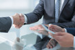 © ASDF - Two confident businessmen shaking hands during a meeting in the