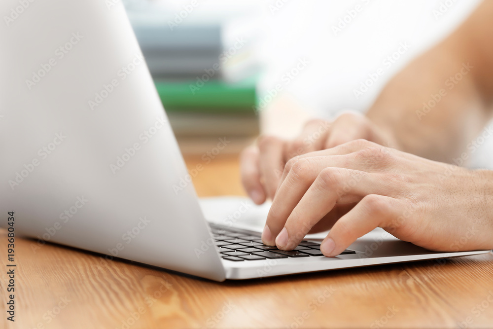 Student preparing assignment on laptop, closeup. Studying process