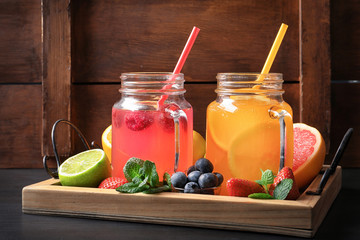 Poster - Tasty lemonades with berries and citrus fruits in mason jars on table