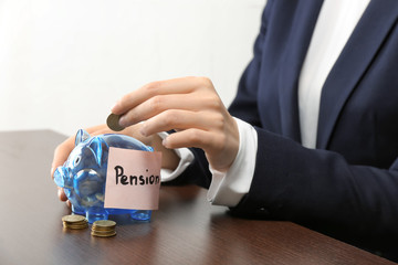 Wall Mural - Woman putting coin into piggy bank with label 