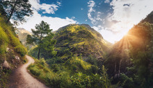 Amazing Scene With Himalayan Mountains Covered Green Grass And Trees, Blue Cloudy Sky With Sun, Clouds And Beautiful Path In Nepal At Sunset. Panoramic Landscape .Mountain Valley. Travel In Himalayas