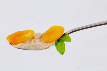 Poster - spoon of oatmeal porridge with apricots