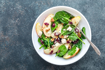 Sticker - salad bowl of spinach, apple, soft cheese, nuts and cranberry. top view, healthy diet eating, superfood