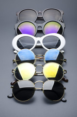 Wall Mural - set of sunglasses in a row isolated on black