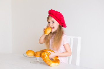  little girl face, red hat, baking bread, close up