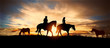 couple on horseback at sunset