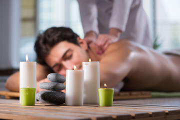 Wall Mural - Young handsome man during spa procedure