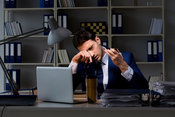 Businessman tired and sleeping in the office after overtime hour