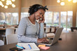 © Flamingo Images - Smiling African university student listening to music between cl