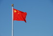 Chinese flag waving in the wind with clear blue sky