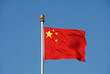 Chinese flag waving in the wind with clear blue sky