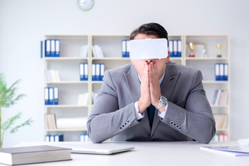 Businessman with virtual reality glasses in modern technology co