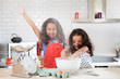 © Lisa Tichané - Sisters getting up to mischief in the kitchen while baking together