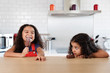 © Lisa Tichané - Little girls at kitchen counter eating ice cream bars
