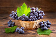 fresh grape with leaves in a basket