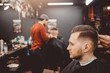 © Parilov - Barbershop. Man with beard in barber shop. Modern hair salon
