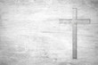 White old christian religion symbol cross shape as sign of belief on a grungy wood textured with copy space.