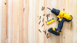 © Aboltin - yellow screwdriver on a wooden table, screws, a set of bits.