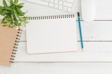 Wall Mural - empty open notebook on white wood table top view,flat lay photo of office desk with mouse and keyboa