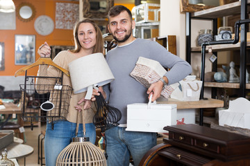 Wall Mural - Smiling family demonstrating their buies in shop