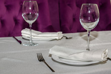 On The Table With A White Tablecloth Is A Cutlery For Two That Is Made Up Of Forks, Knives, Plates, Glasses For Wine, White Napkins
