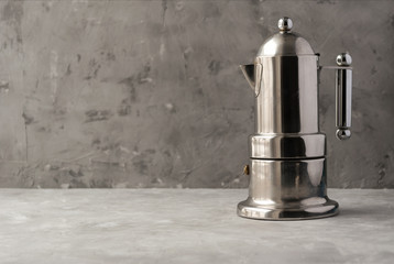 Metal italian moka coffee pot. Espresso maker on grey background.