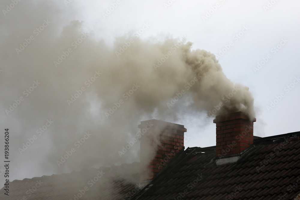 Brown smoke from chimney house due to combustion of coal - obrazy, fototapety, plakaty 