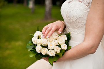 Wall Mural - Young bride in wedding dress holding bouquet