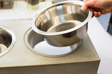 Woman preparing dog food bowl