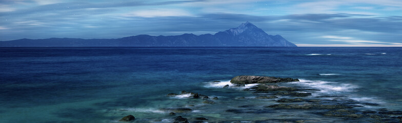 Wall Mural - moonlight over holy mountain athos, halkidiki, greece. starry sky night with moving clouds. long tim