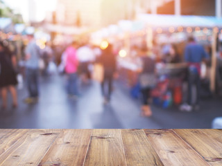 table top over blurred background of people shopping at market fair