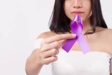 Woman Hand Holding Purple Ribbon Bow, Lupus LSE Or Alzheimer Awareness Symbol; Purple Ribbon For Medical, Charity Fund Raising Concept For Lupus Or Alzheimer Patient Or Prevention
