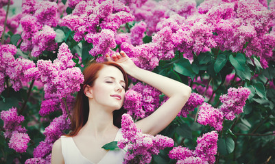 Wall Mural - girl standing near lilac bushes in the park