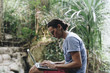© Rawpixel.com - White man using computer laptop at waterfall
