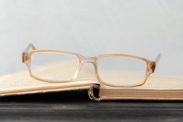 Poster - eyeglasses and book on the table