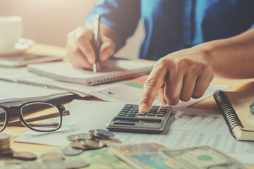 Fototapete - businesswoman working in office using calculator to calculate budget. concept finance and accounting