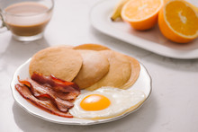 Breakfast Plate With Pancakes, Eggs, Bacon And Fruit.