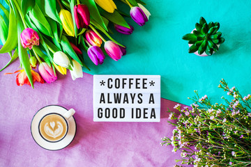 Coffee always a good idea written in lightbox with spring flowers from above