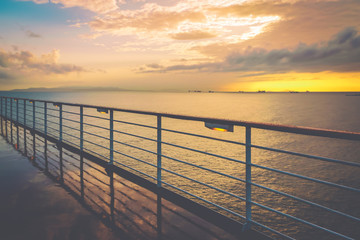 Poster - Cruise ship railing at sunset after a rainy day.