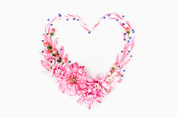 Wall Mural - Beautiful floral arrangements. Pink chrysanthemums in the shape of heart frame on white background. Flat lay, top view.