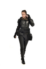 Sticker - full length portrait of female  soldier wearing black  tactical armour, isolated on white studio background.