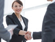 © ASDF - Businesswoman shaking hands with a businssman during a meeting