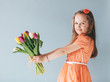 © Photocreo Bednarek - Girl holding a bunch of colorful tulips.