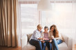 © Halfpoint - A teenage girl, mother and grandmother with tablet at home.
