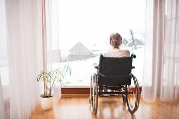 Canvas Print - Senior woman in wheelchair at home.