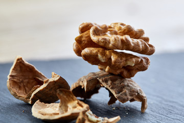 Top view close-up shot of cracked walnuts on dark background, shallow depth of field, macro