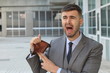 Businessman crying holding his empty wallet