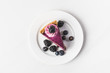 © LIGHTFIELD STUDIOS - top view of blueberry cake with fresh berries on plate isolated on white