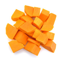 A Group Of Cut And Slice Butternut Squash Chunks On A White Background.